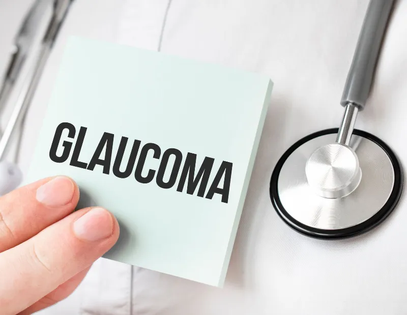 Doctor holding card in hands and pointing the word GLAUCOMA
