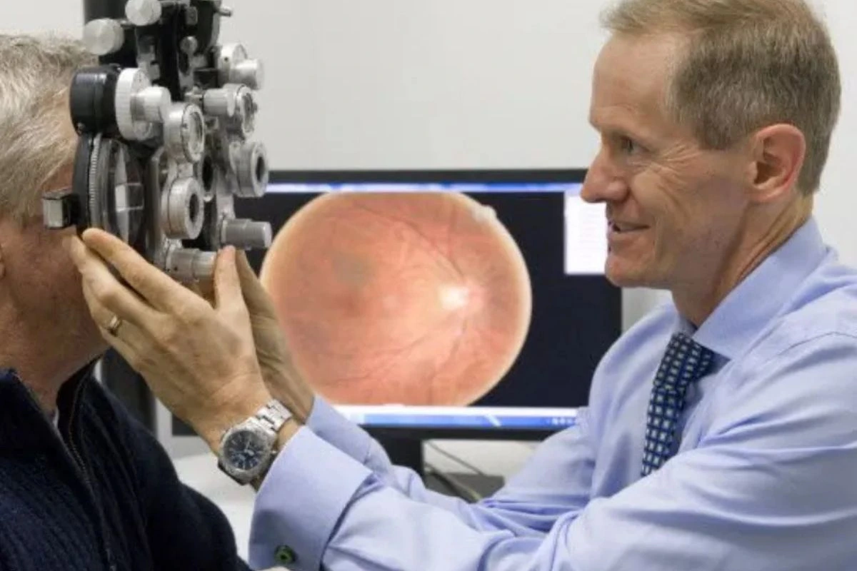 The doctor is checking the man's eyes